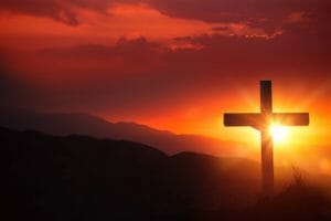 The Light of Christ Old Wooden Crucifix on the Desert During Scenic Sunset. Christian Cross Sunset Background.